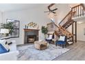 This open-concept living room has a fireplace and wooden staircase at 10836 W Evans Ave # 32, Lakewood, CO 80227