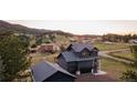 Dark modern home situated on a lush lot with picturesque views and a detached two car garage at 30796 Burland Rd, Golden, CO 80403