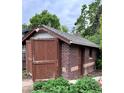 View of garage with brick exterior and wooden doors at 2835 Cherry St, Denver, CO 80207
