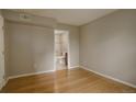 Bedroom with wood floors and an ensuite bathroom featuring a walk-in shower at 3550 S Harlan St # 259, Denver, CO 80235
