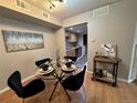 Cozy dining area featuring a glass table and views to the kitchen at 3550 S Harlan St # 259, Denver, CO 80235