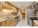 Well-equipped kitchen with stainless steel appliances and adjacent laundry at 3550 S Harlan St # 259, Denver, CO 80235