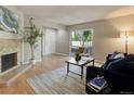 Cozy living room with a sliding glass door, fireplace, and neutral decor with a comfortable sofa at 3550 S Harlan St # 259, Denver, CO 80235