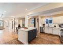 Modern kitchen featuring a kitchen island with countertop, stainless steel appliances, and white cabinetry at 2163 S Grant St, Denver, CO 80210