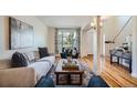 Comfortable living room with hardwood floors, a large sofa, and bright window at 2163 S Grant St, Denver, CO 80210