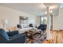 Cozy living room featuring a comfortable sofa, stylish armchairs, and a colorful rug at 2163 S Grant St, Denver, CO 80210