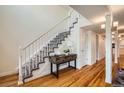 Bright staircase with carpeted steps, wooden floors, and white banister at 2163 S Grant St, Denver, CO 80210