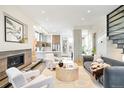 Open-concept living room boasts a fireplace, comfortable seating, and seamless flow to the kitchen at 2659 S Cherokee St, Denver, CO 80223