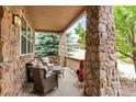 Inviting front porch with stone columns and comfortable seating at 6542 S Tempe St, Aurora, CO 80016