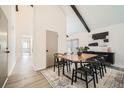 Bright dining area with vaulted ceilings, modern furnishings, and stylish black accents at 1696 Geneva Cir, Longmont, CO 80503