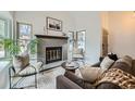 Cozy living room with brick fireplace, plush seating, and stylish accents at 1696 Geneva Cir, Longmont, CO 80503