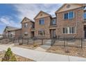 Inviting exterior showcasing the townhome's brick facade, walkway, and well-kept landscaping at 6777 S Old Hammer Ct, Aurora, CO 80016