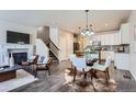 Open-concept living space featuring a fireplace, modern dining area, and stylish furnishings at 6777 S Old Hammer Ct, Aurora, CO 80016