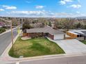 Aerial view of a brick home with a well-manicured lawn and attached two-car garage at 2698 E Cresthill Ave, Centennial, CO 80121