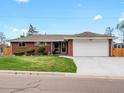 Charming brick home featuring a well-maintained lawn and an attached two-car garage at 2698 E Cresthill Ave, Centennial, CO 80121
