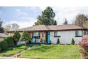 Charming home featuring a well-maintained lawn, a mix of modern siding, and a welcoming front porch with blue chairs at 11354 Allendale Dr, Arvada, CO 80004