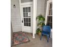 Cozy front entrance features a white door, blue chair, and decorative rug at 7481 Singing Hills Dr, Boulder, CO 80301