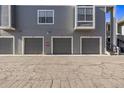 Exterior view showing multiple gray garages with unit numbers and paved parking area at 7481 Singing Hills Dr, Boulder, CO 80301