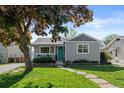 Attractive home featuring lush lawn, mature trees, and a beautifully updated exterior paint scheme at 2385 S Marion St, Denver, CO 80210