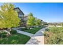 Street view of charming neighborhood homes with sidewalks and common green space at 12777 Ulster St, Thornton, CO 80602