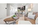 Bright living room and dining area with neutral decor and modern finishes at 12777 Ulster St, Thornton, CO 80602
