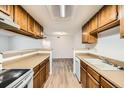 Well-lit kitchen with a serving hatch, complete with essential appliances and ample storage cabinets at 18073 E Ohio Ave # 203, Aurora, CO 80017