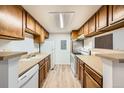 Efficient kitchen layout with wood cabinetry, modern appliances, and ample counter space at 18073 E Ohio Ave # 203, Aurora, CO 80017