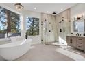 Spa-like bathroom with soaking tub, walk-in shower, and modern vanity at 25220 Montane Dr, Golden, CO 80401