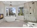 Bathroom with soaking tub, walk-in shower and fireplace at 25220 Montane Dr, Golden, CO 80401