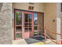 Close up of glass doors with A7 unit number and ramp access, nestled in a stucco and brick exterior at 7755 E Quincy Ave # 301A7, Denver, CO 80237