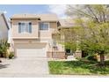 Beautiful home featuring a well-manicured lawn, a two-car garage, and mature trees at 9469 W Ute Dr, Littleton, CO 80128