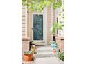 Inviting front porch decorated with colorful potted plants, enhancing the home's curb appeal at 9469 W Ute Dr, Littleton, CO 80128
