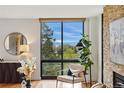 Cozy living room features hardwood floors, scenic outdoor views from large windows, and comfortable chair at 1111 Race St # 6B, Denver, CO 80206
