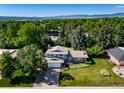 An aerial view of a home surrounded by lush greenery, offering privacy and serenity with mountain views in the distance at 5404 W Rowland Pl, Littleton, CO 80128