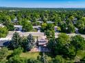 An aerial view of a home on a tree-lined street, showcasing its backyard patio, and surrounding neighborhood at 5404 W Rowland Pl, Littleton, CO 80128
