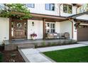 Inviting front porch with outdoor seating, beautiful wooden door, and stylish potted flowers at 5810 S Galena St, Greenwood Village, CO 80111