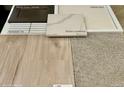Interior design elements showcase vinyl plank flooring, carpet, quartz countertops, and cabinet and backsplash samples at 2234 Farmlore Dr, Brighton, CO 80601