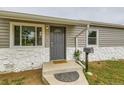 Close up of home entry featuring newly installed gray siding and painted door at 9470 Lillian Ln, Thornton, CO 80229
