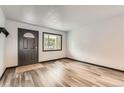 Bright living room with wood-look flooring, fresh paint, and new trim at 9470 Lillian Ln, Thornton, CO 80229