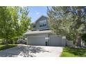 A well maintained two story home with a three car garage and mature trees in the front yard at 20234 E Lake Cir, Centennial, CO 80016