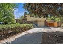 Charming two-story home with a brick facade, complemented by a well-manicured lawn and lush greenery at 8346 W Woodard Dr, Lakewood, CO 80227