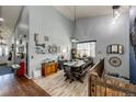 Cozy dining area with a rustic table set, wood floors, and a decorative collection of wall art at 11699 Pink Phlox Dr, Parker, CO 80134