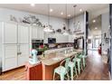 Bright kitchen with long island, bar seating, granite countertops and stainless steel appliances at 11699 Pink Phlox Dr, Parker, CO 80134