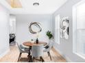 Light-filled dining room features wood table, gray chairs, and open floor plan at 1838 Race St, Denver, CO 80206