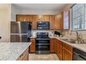 This kitchen features stainless steel appliances, wooden cabinets, and plenty of counter space at 9461 Ashbury Cir # 104, Parker, CO 80134