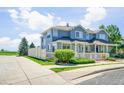 Well-manicured townhome featuring a white picket fence, lovely landscaping, and a charming exterior at 9102 W 107Th Pl, Broomfield, CO 80021