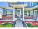 Inviting townhome exterior with brick accents, decorative planters, and beautiful landscaping at 9102 W 107Th Pl, Broomfield, CO 80021