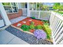 Charming townhome landscaping with colorful flowerbeds, stone accents, and meticulous design at 9102 W 107Th Pl, Broomfield, CO 80021