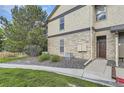 Charming condo exterior featuring stone accents, a well-kept lawn, and convenient access to the front door at 7418 S Quail Cir, Littleton, CO 80127