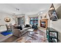 Comfortable living room with a cozy fireplace adjacent to dining area with sliding doors to balcony at 100 S Park Ave # E312, Breckenridge, CO 80424